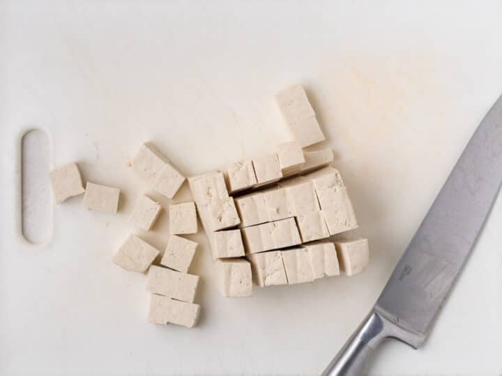 extra-firm tofu cut into small cubes on a cutting board