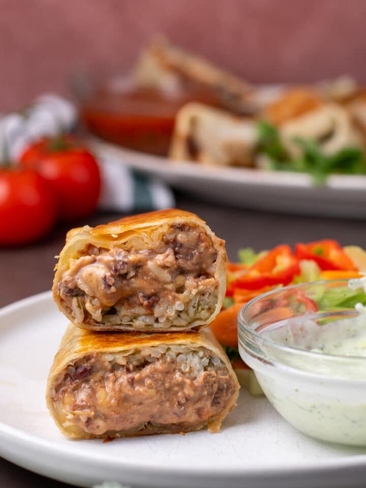 cross section view of cheesy bean and rice mixture inside a burrito