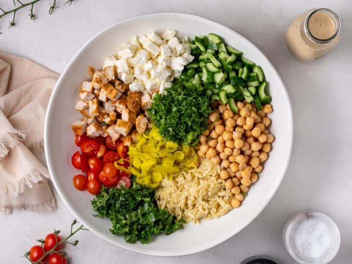chicken and chickpea salad assembled in a large white serving bowl