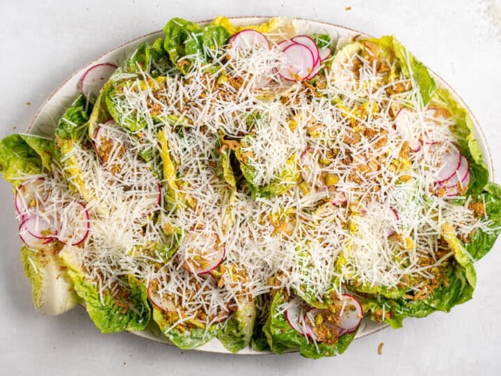 little gem salad recipe with Caesar vinaigrette and freshly grated parmesan cheese