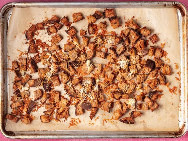 Golden garlic parmesan croutons baked until crispy on a sheet pan