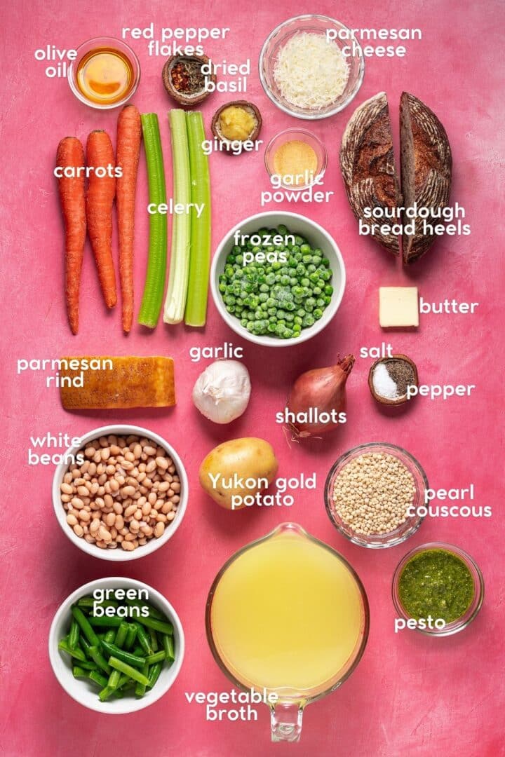 Overhead view of labeled ingredients for springtime minestrone soup including carrots, celery, peas, white beans, couscous, pesto and vegetable broth