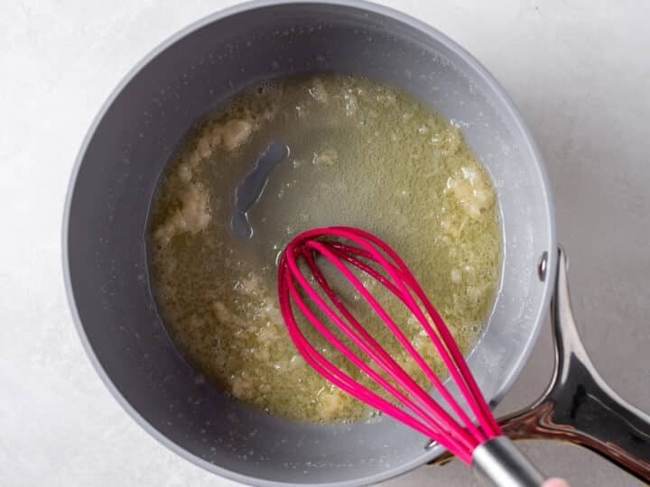 Melting butter with minced garlic in a saucepan for creamy garlic sauce