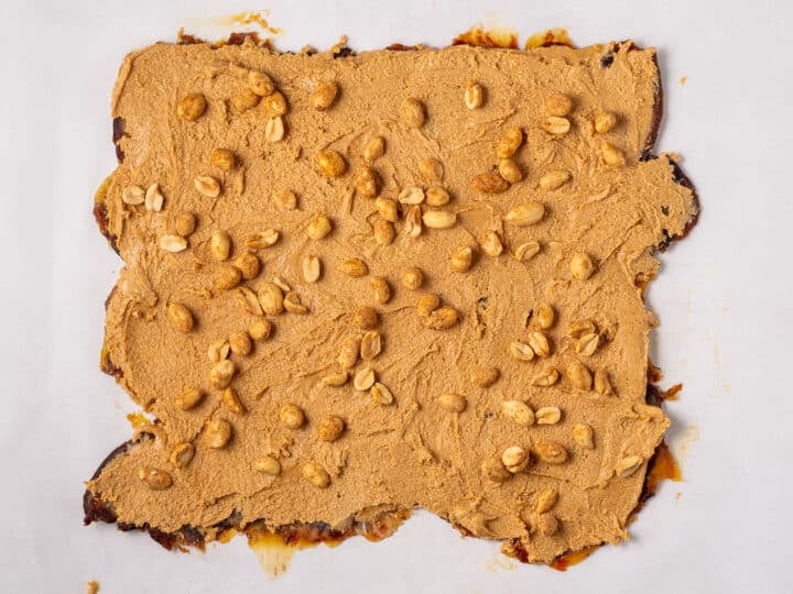 Chopped peanuts scattered over the peanut butter layer