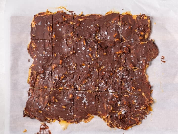 Chocolate peanut butter date bark cut into squares after cooling