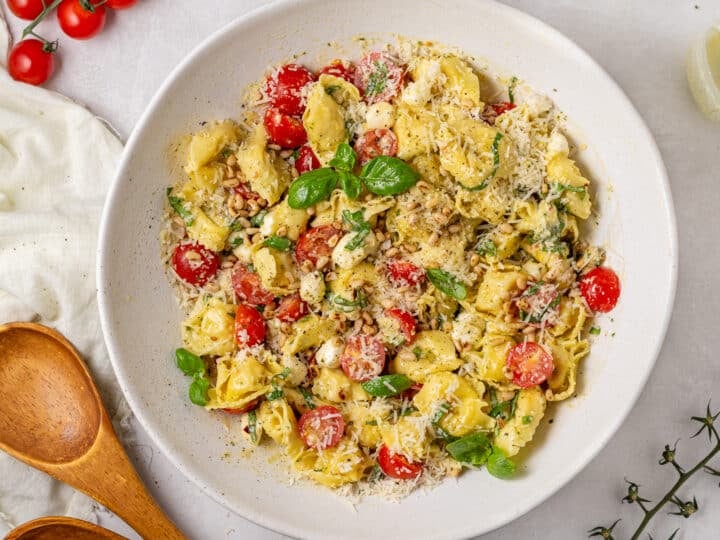mixed tortellini salad with cherry tomatoes, basil, mozzarella cheese and pesto vinaigrette