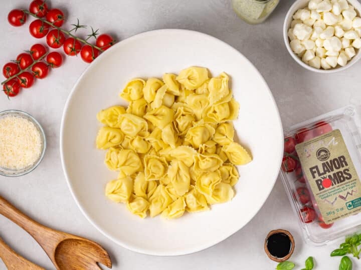 cooked cheese tortellini in a large white bowl