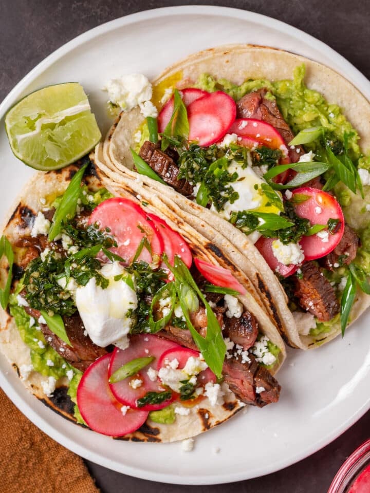 skirt steak tacos with pickled radishes, cilantro chimichurri and sour cream