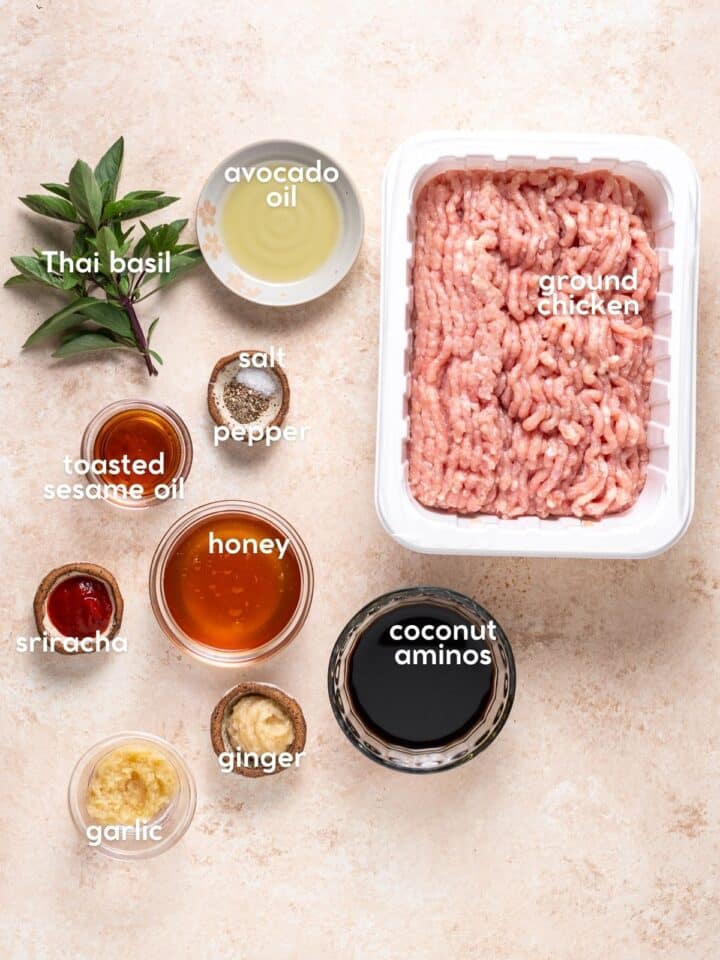 Ingredients for recipe including ground chicken, Thai basil, coconut aminos, honey, ginger paste, garlic, sriracha, sesame oil, avocado oil, salt and pepper.