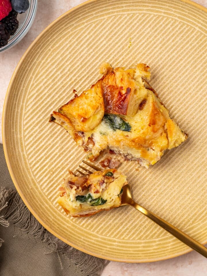 gold fork taking a bite out of a slice of high protein egg bake