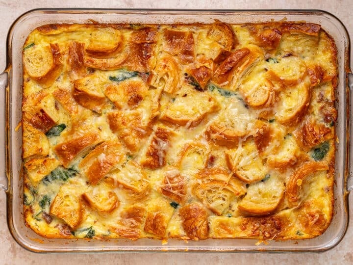 baked high protein egg bake with caramelized shallots, spinach, bacon and crispy croissant topping