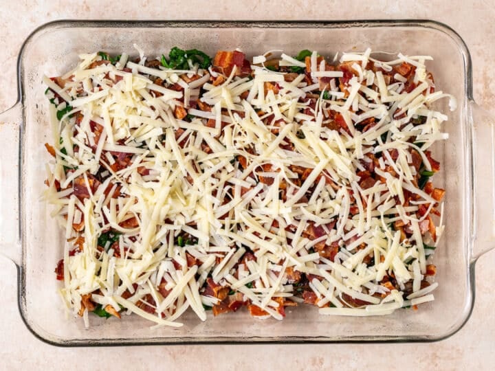 veggies, bacon and cheese layered in a baking dish
