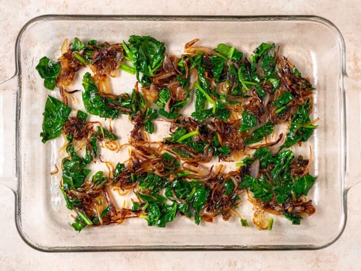 caramelized shallots and spinach in a baking dish