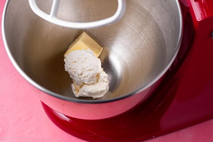 Softened butter and cream cheese in the bowl of a stand mixer.