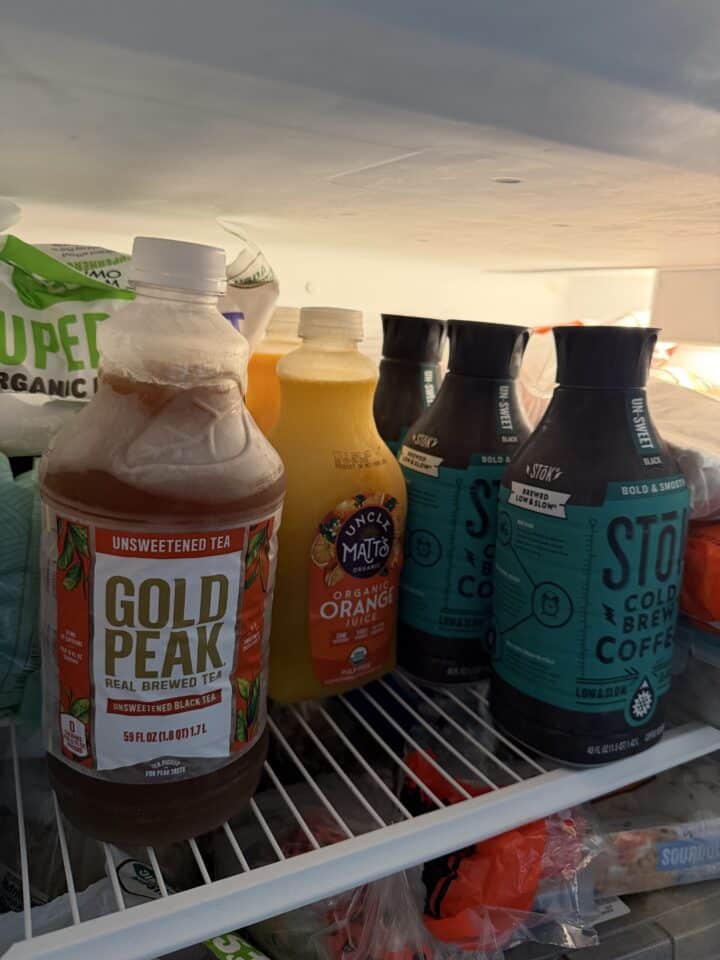 jugs of iced tea, orange juice, and cold brew coffee in the freezer