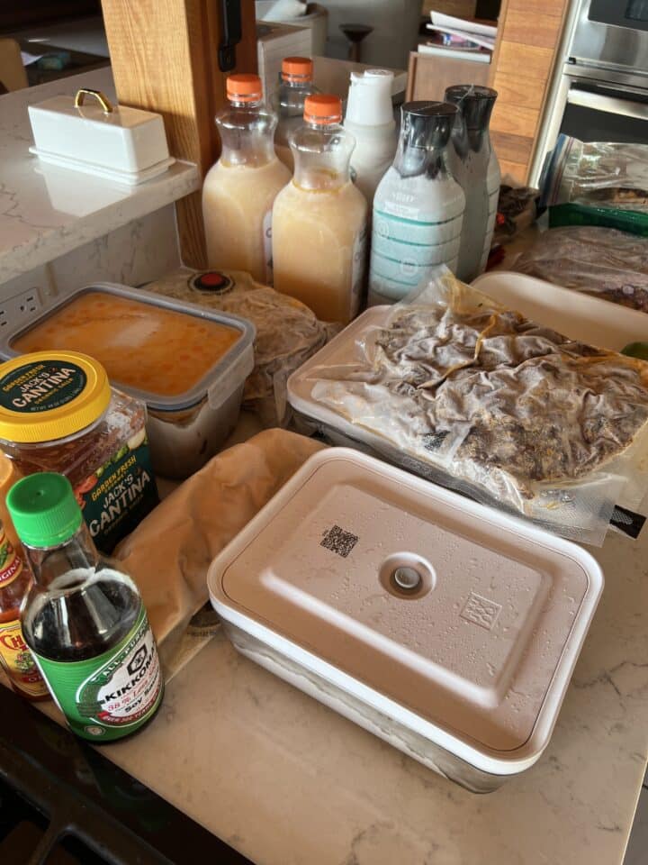 frozen proteins in freezer gallon bags, frozen drinks, and frozen condiments on countertop