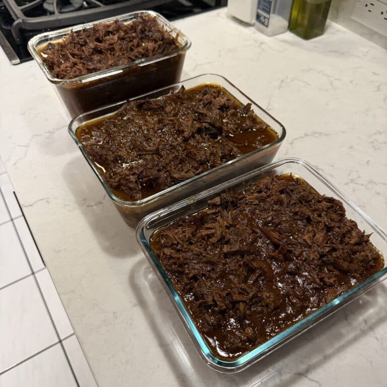 Korean shredded beef packed into three uniform glass containers on the counter top