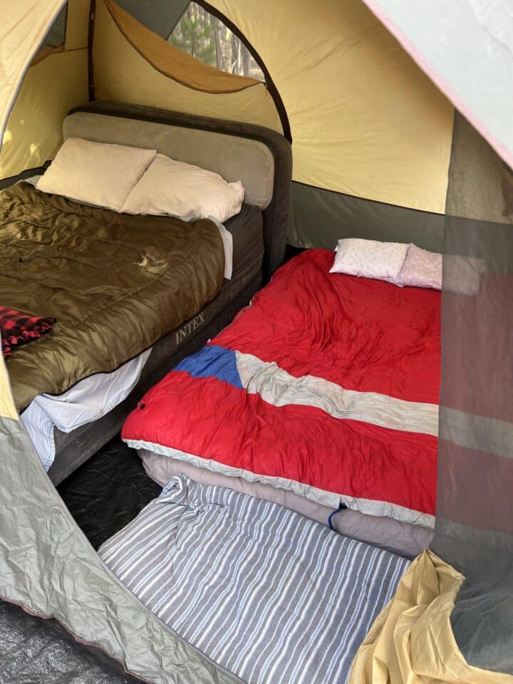 sleeping tent with two air mattresses and a dog bed