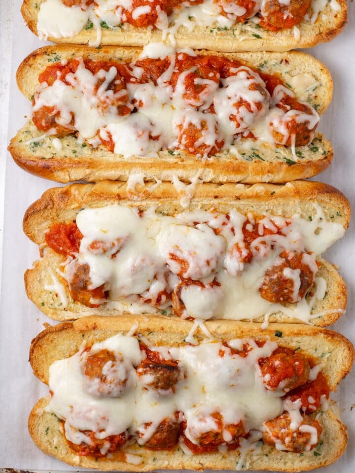 Garlic bread meatball subs topped with marinara sauce and melted mozzarella.