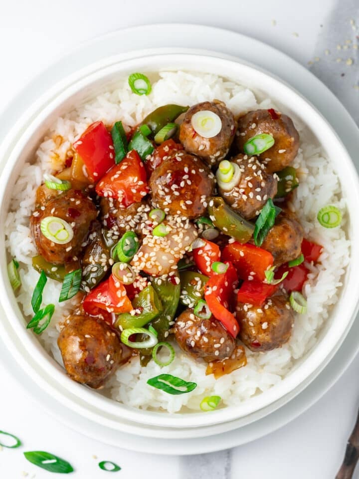 Sweet chili meatballs with bell peppers and onions served over white rice.