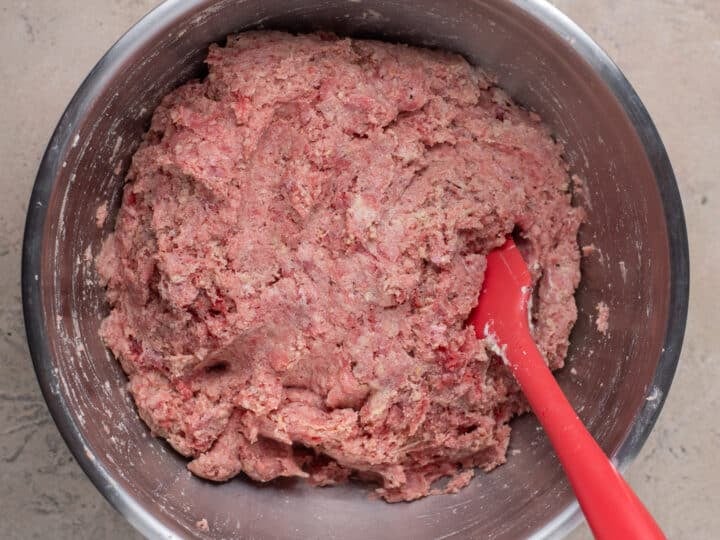 Ground beef and ricotta meatball mixture in a large mixing bowl.