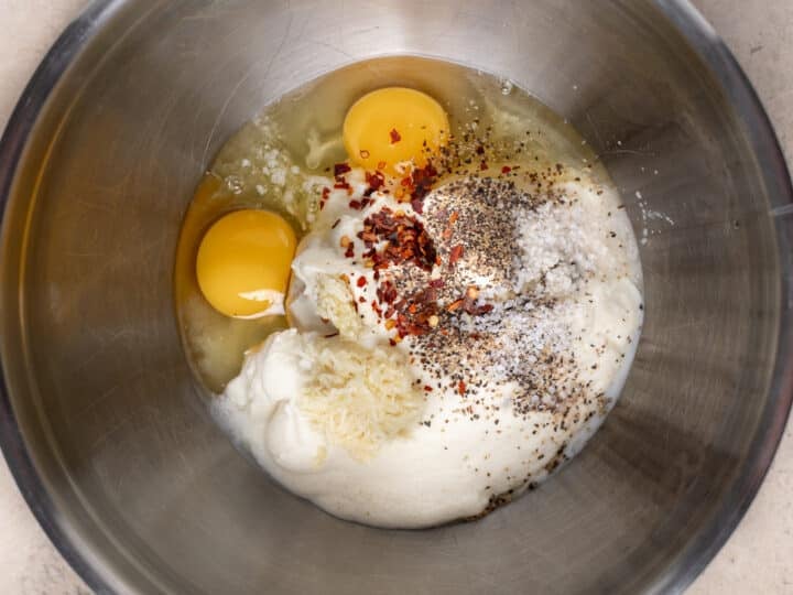 Ricotta, eggs, grated garlic, and seasonings in a large bowl.