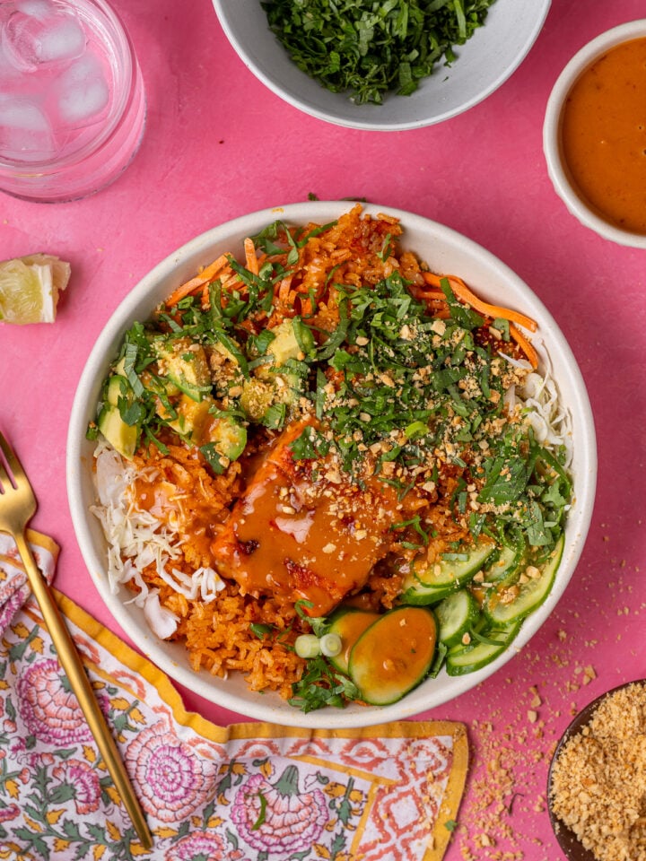 Thai salmon crispy rice salad topped with sweet chili peanut sauce, crushed peanuts and fresh herbs