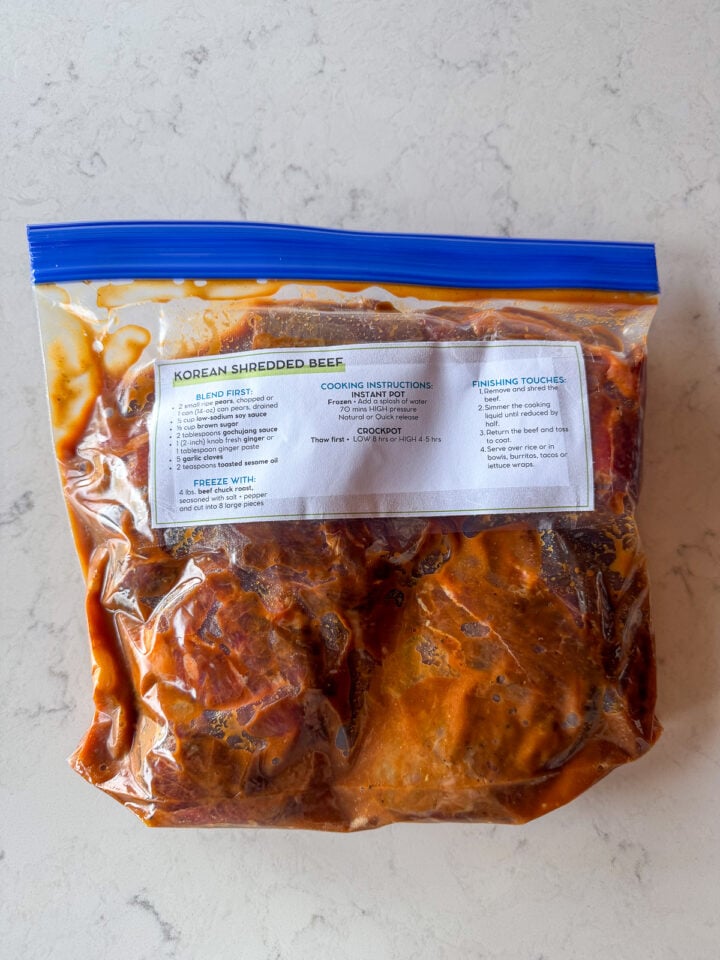 Freezer meal prep for Korean shredded beef prepped with sauce in a labeled bag