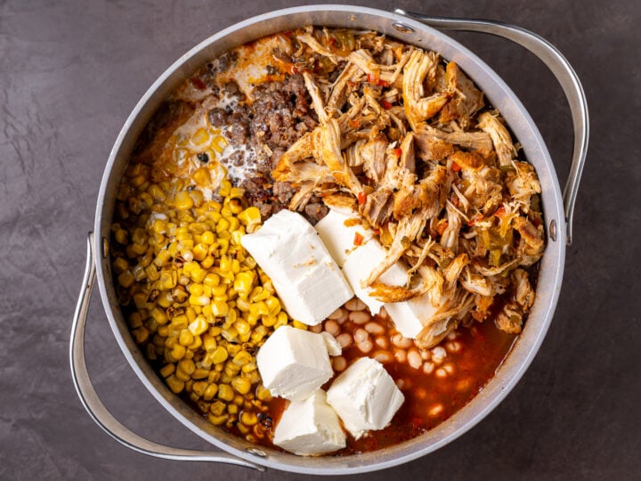 Shredded chicken, cream cheese and half-and-half added to white beans, roasted corn and Italian sausage in the pot.