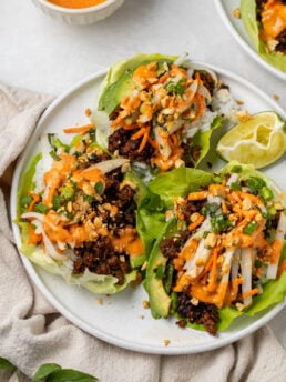 Gochujang ground beef lettuce wraps with rice, avocado, pickled Asian pear slaw, peanuts and spicy aioli
