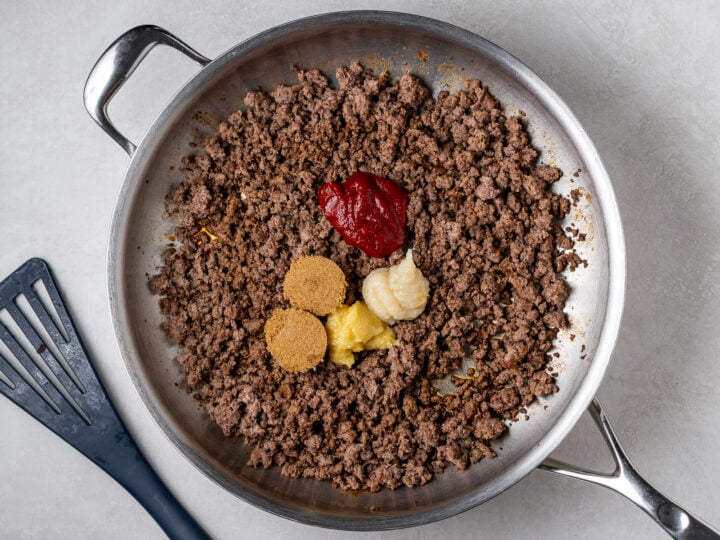 Cooked ground beef with gochujang sauce, brown sugar, garlic and ginger paste added to the skillet