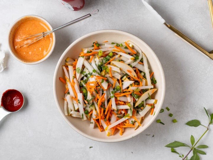Pickled Asian pear slaw tossed with shredded carrots, fresh herbs and green onions