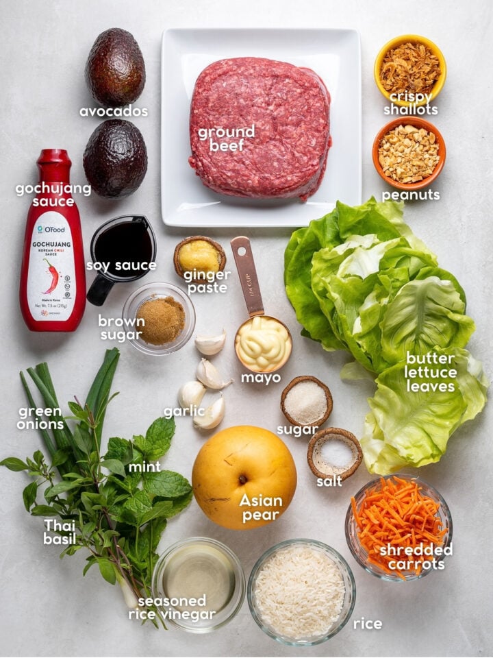 Ingredients for Korean beef lettuce wraps including gochujang sauce, low sodium soy sauce, ginger, garlic, Asian pear, herbs, avocado and butter lettuce leaves