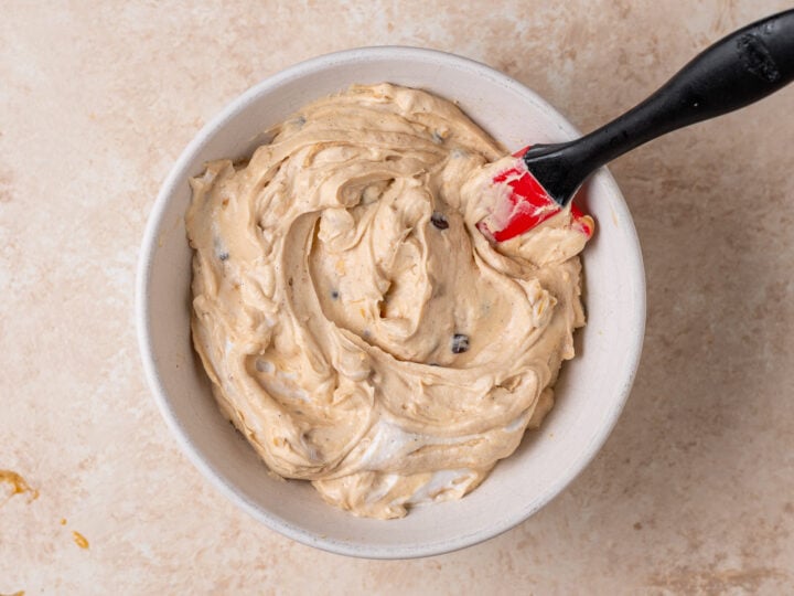 Peanut butter Greek yogurt fruit dip ingredients stirred together in a bowl