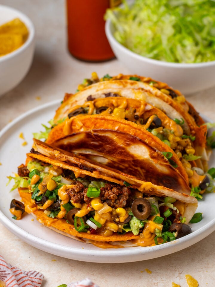 Crispy cheesy gordita crunch tacos filled with seasoned ground beef, lettuce, corn, black olives, green onions and creamy orange sauce.